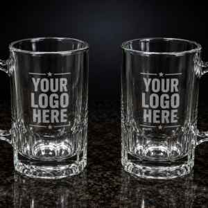 Custom etched glass beer stein with tall cylindrical body, faceted octagonal base, thick C-handle, and personalized frosted heraldic crest with arched script.