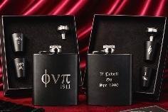 Two matte black flask sets with Phi Nu Pi 1911 and personalized engraving, each with cups and funnel