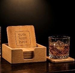 Four square bamboo coasters in a matching bamboo holder engraved "your logo here", with a whiskey glass beside