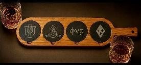 Wood serving paddle with four inset engraved coasters and two rocks glasses at either end