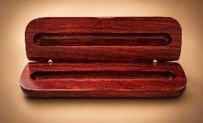 Open rosewood single-groove pen and pencil case on a warm tan background