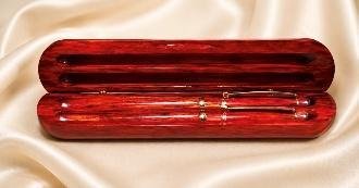 Open rosewood two-groove case holding a matching rosewood pen and pencil