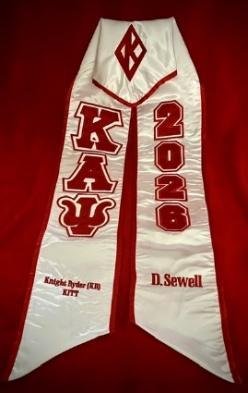 White graduation stole with crimson Greek letters, a diamond insignia, the year 2026 and personalized names