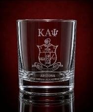 Rocks glass etched with a Kappa Alpha Psi crest and chapter text on a deep red backdrop
